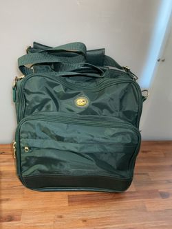 This is a hunter green Ricardo Beverly Hills travel bag with a distinctive gold emblem on the front.🙆🏻‍♀️🤩