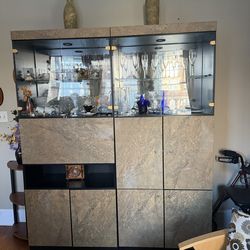 Modern glass display cabinet with storage.