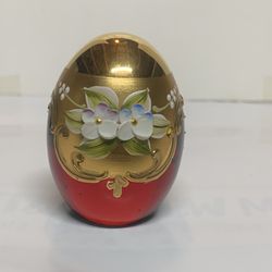 vintage Ferro & Lazzarini Murano ruby red glass egg paperweight.  It features hand-painted gold and enamel floral decoration. The piece stands approxi