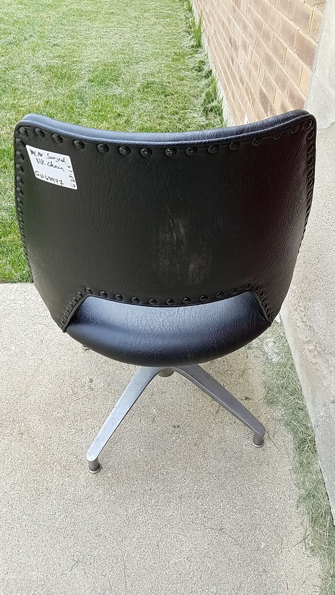 MCM black studded vinyl swivel chair