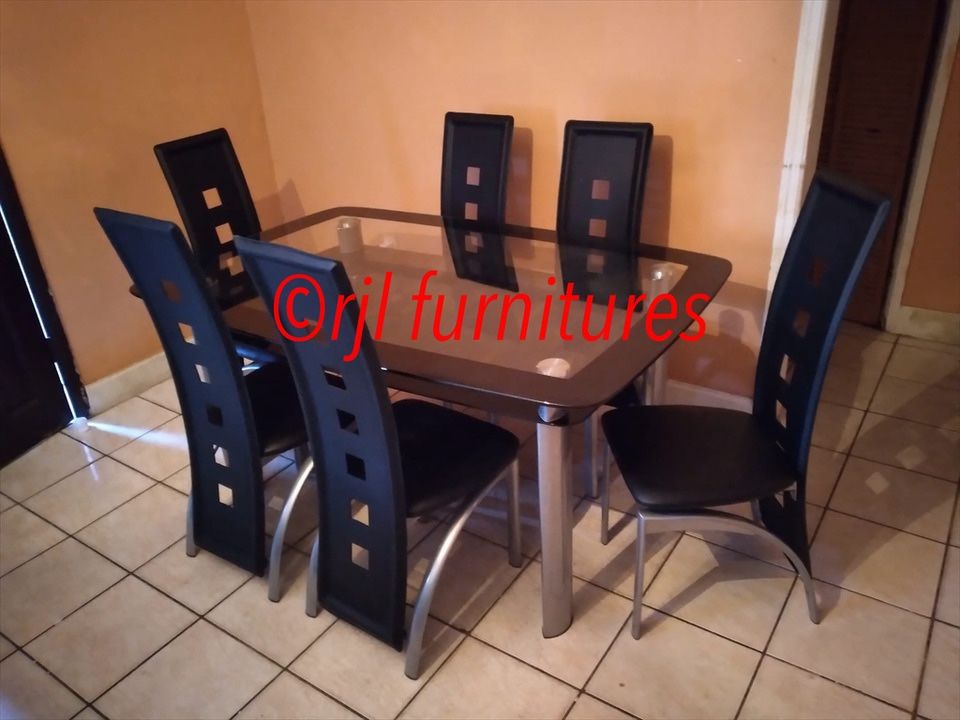 7 Black pieces dining set new in the box . Glass table and 6 chairs 575