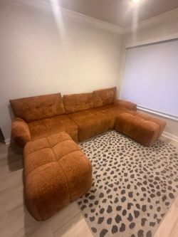Orange Couch with two ottomans