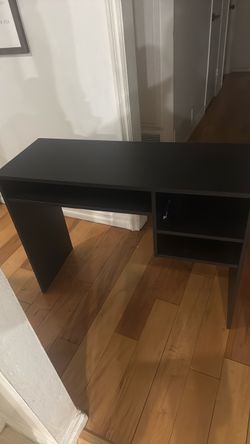 Small desk for laptop work and monitor.