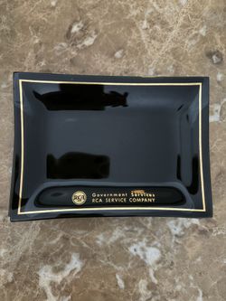 vintage 1960s RCA Government Services 7 plate or ashtray. It is a smoked glass item with gold trim and lettering. 
