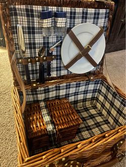 Cute wicker picnic basket with accessories