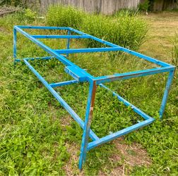 Metal frame table with a lower shelf