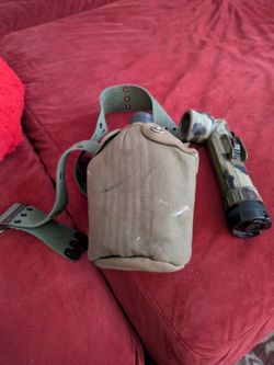 Vintage military flashlight and canteen