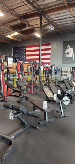 Smith machine squat rack home gym dumbbells kettlebells rubber flooring bench bar leg press weights bumper plates