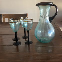 Glass pitcher and four glasses