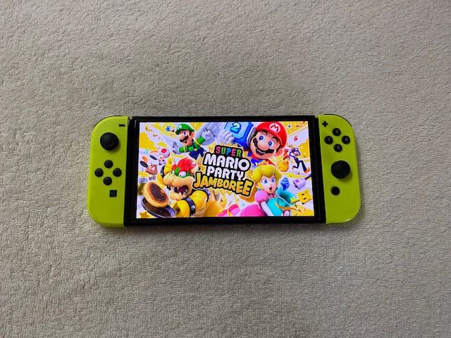 NINTENDO SWITCH OLED with 125 GAMES MARIO JAMBOREE,POKEMON,MARIO KART,ZELDA,MORTAL KOMBAT and Many More