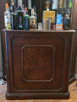 Dark cherry finish wood bar table and curio cabinet