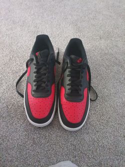 Black Nike shoes with red accents