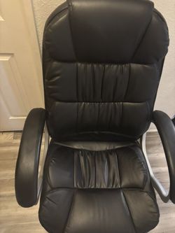 Padded, adjustable office chair on wheels.