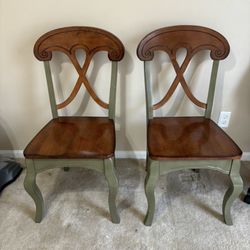 Two wooden dining chairs