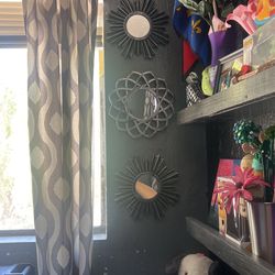 A set of three small designed mirrors plastic
