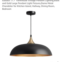 Eustace 17.7" Large Pendant Light in a matte black and gold finish.  Features a dome shade crafted from sturdy metal with a black finish and a copper-