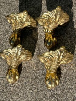 4 Solid brass, ornate claw feet. In good condition Each way is roughly 6 pounds. Very solid sturdy and ready to be mounted on something. $100, Or be