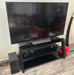 65” Sony Bravia, tv stand, and Samsung sound bar.