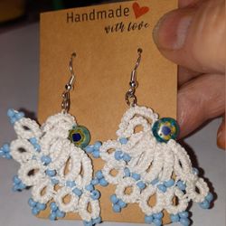 White tatted earrings accented with light aqua beads 