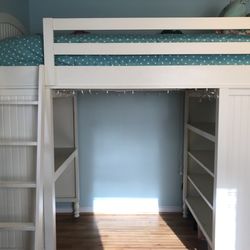 White Twin wooden Pottery Barn loft bed with desk and storage shelves beneath