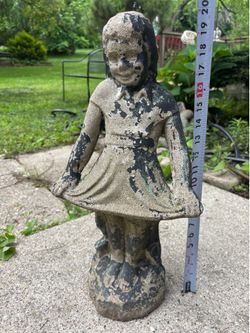Concrete garden statue of young girl