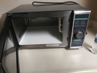 Microwave . table chairs metal rack with pots and pans