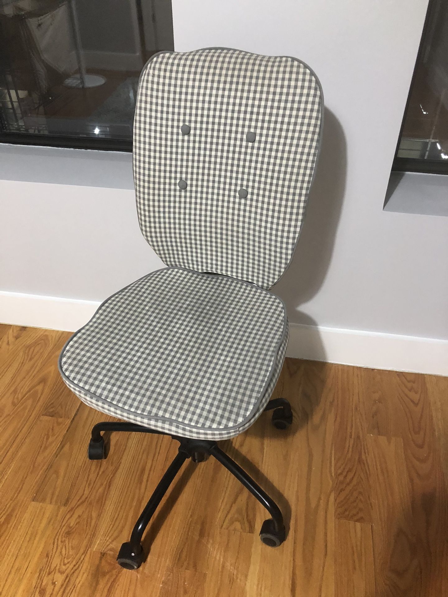 Rolling adjustable desk chair with a gingham print cover
