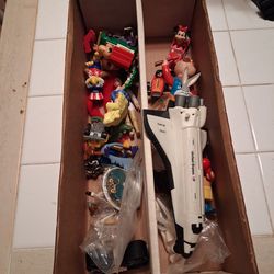 Box of collectible toys mostly from 80s