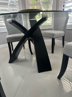 Round dining room table with four chairs included