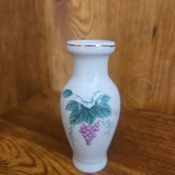 vintage porcelain vase with a grape design and 22-karat gold trim