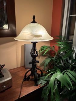 table lamp features heavy wrought iron