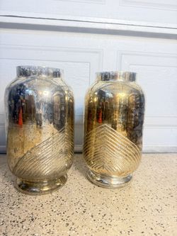 mercury glass with a silver or gold finish and have a distinctive etched linear pattern.