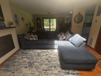 Sectional sofa, carpet, and decorative pillows