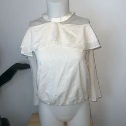 Alice + Olivia "Layla" ruffle blouse. High, halter neckline; keyhole back. Ruffle overlay around top shoulders. Cold shoulders. Bracelet sleeves. Rela