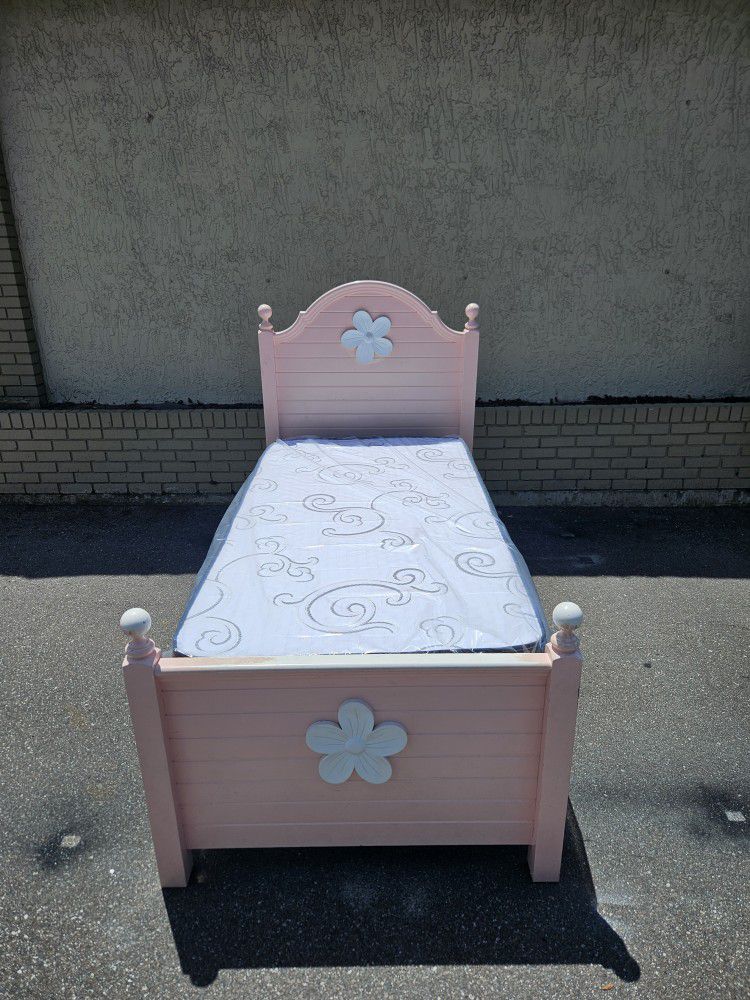 Pink twin-size bed frame with brand-new Twin size mattress with bunkie board in plastics