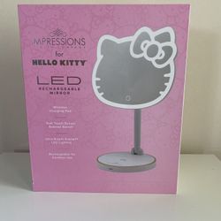 Impressions Vanity Hello Kitty Rechargeable Table Makeup Mirror is shaped after Hello Kitty and outlined with an ultra-bright LED strip light.