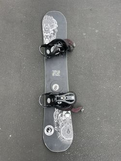 Cool black green snowboard with bindings!
