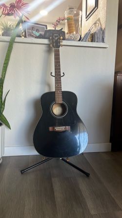 black Yamaha F335 acoustic guitar
