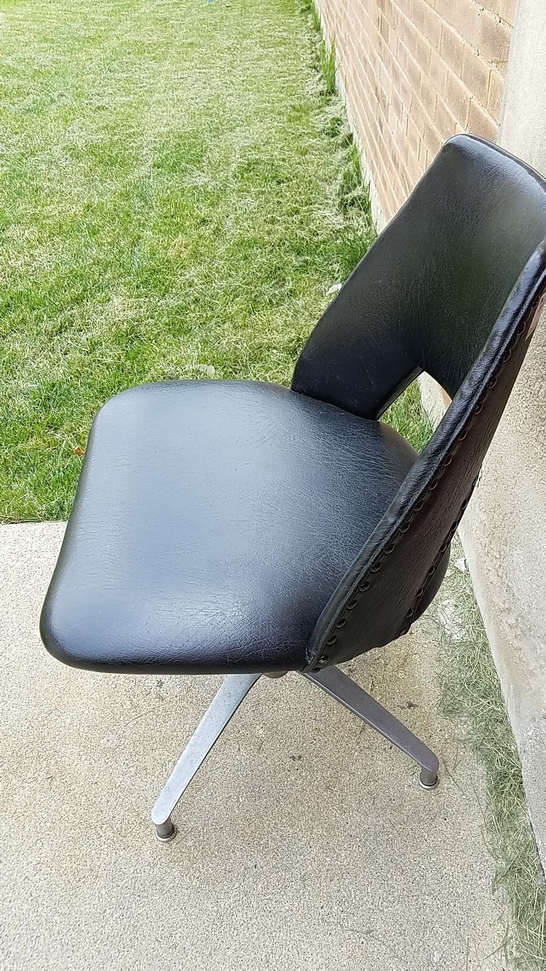 MCM black studded vinyl swivel chair