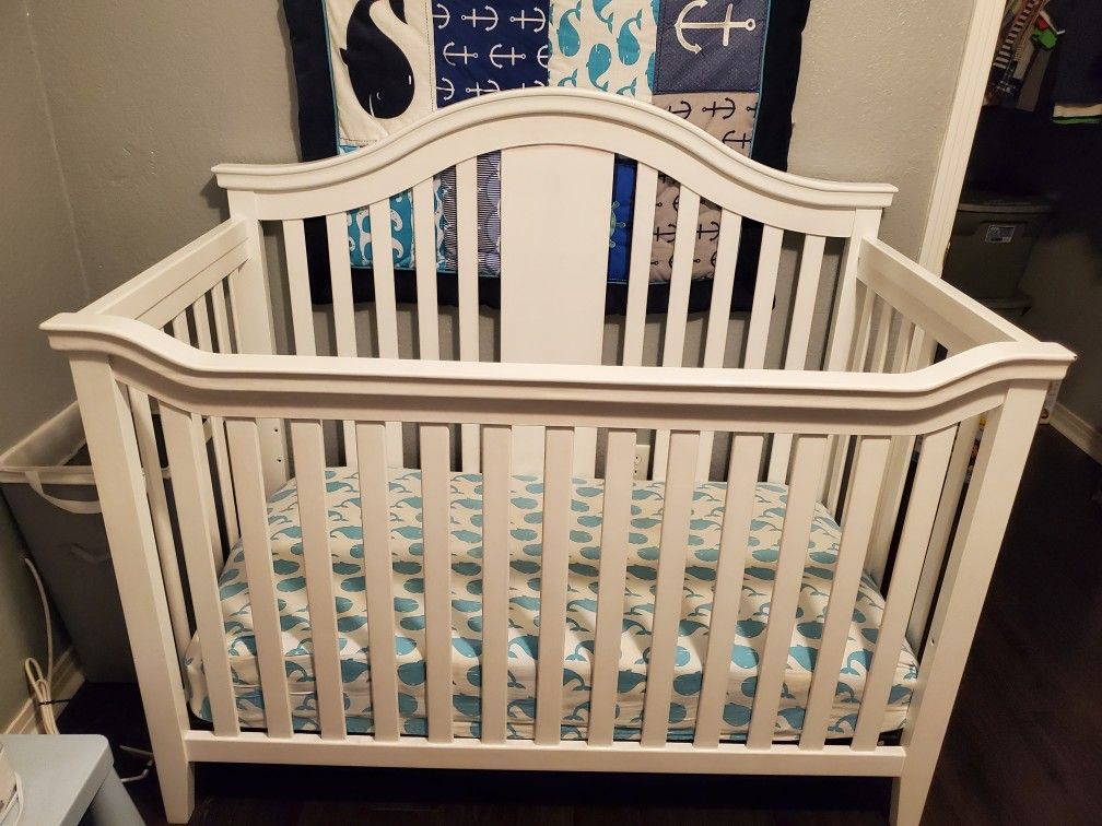 White crib with adjusting heights, white changing table with changing pad and drawer, Sealy mattress 3 years old, and Dekor diaper pail