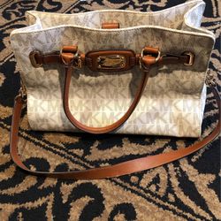 Large white MK bag with light brown lettering.