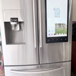 Samsung French-door refrigerator with a Family Hub touchscreen (counter-depth style, stainless steel).
