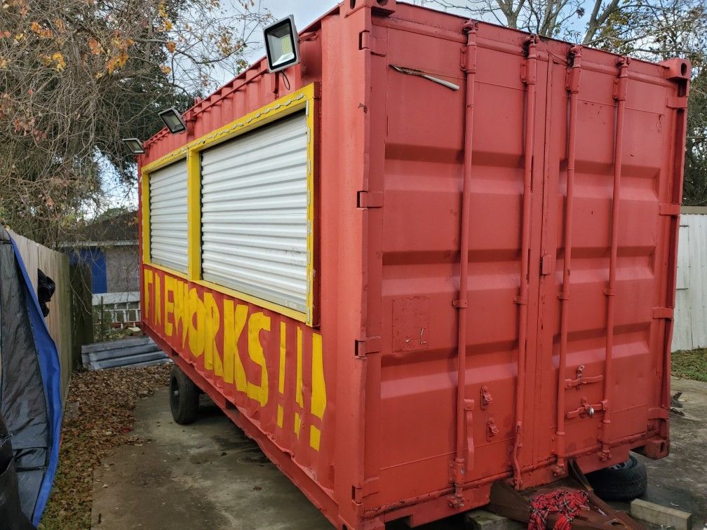 Container firework stand with electric lighting and shelving