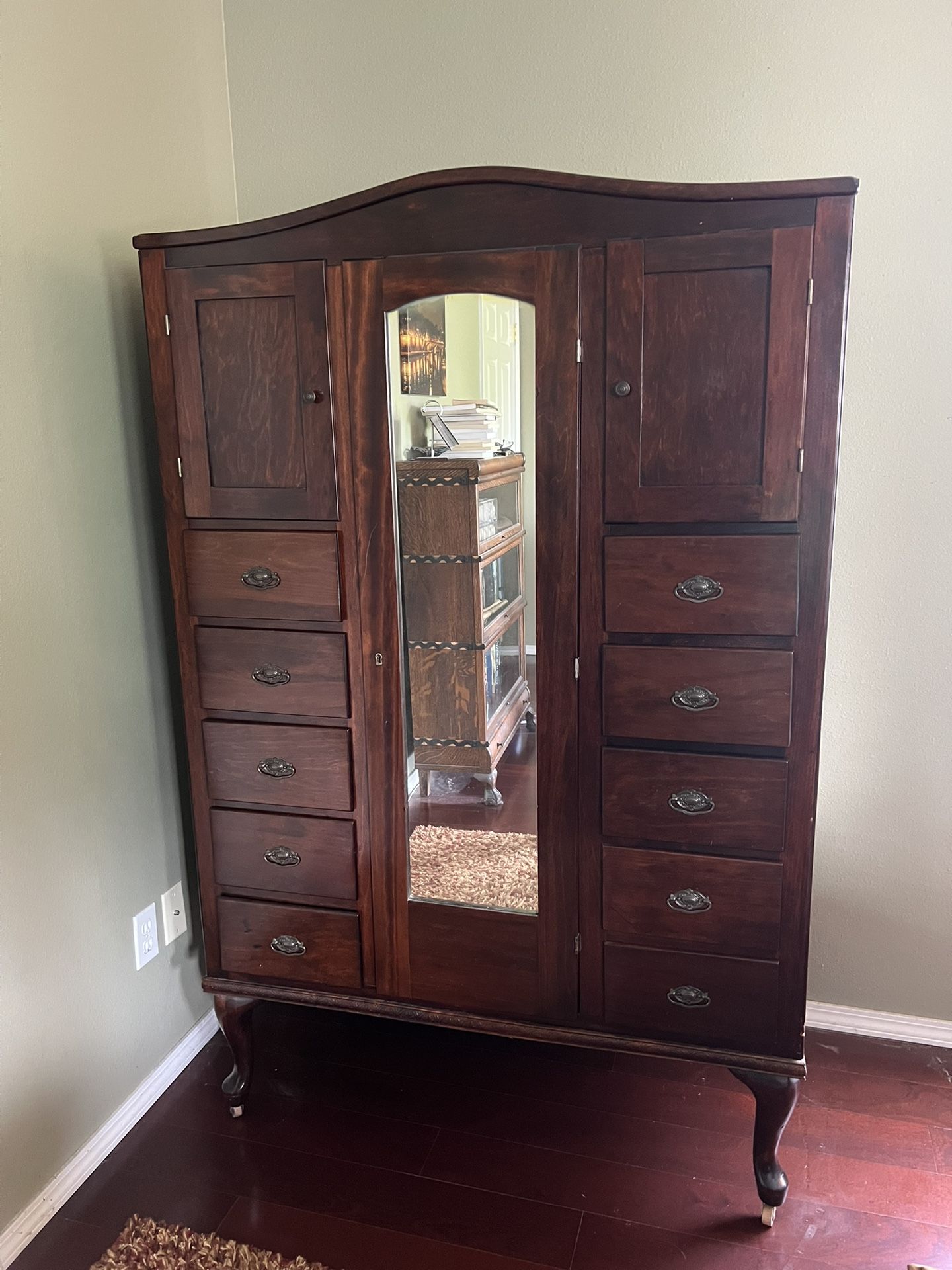 Antique 10 drawer armoire with mirrored middle door