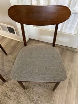 Two mid-century wood dining chairs