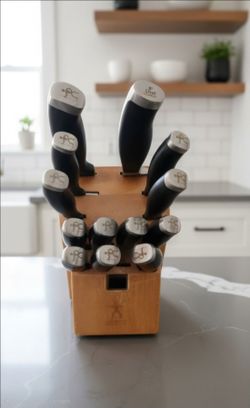 Henckels knife block set features stamped blades designed with micro-serrated edges meant to require no sharpening.