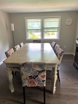 Disassembled dining table set with 8 chairs (seats 8).