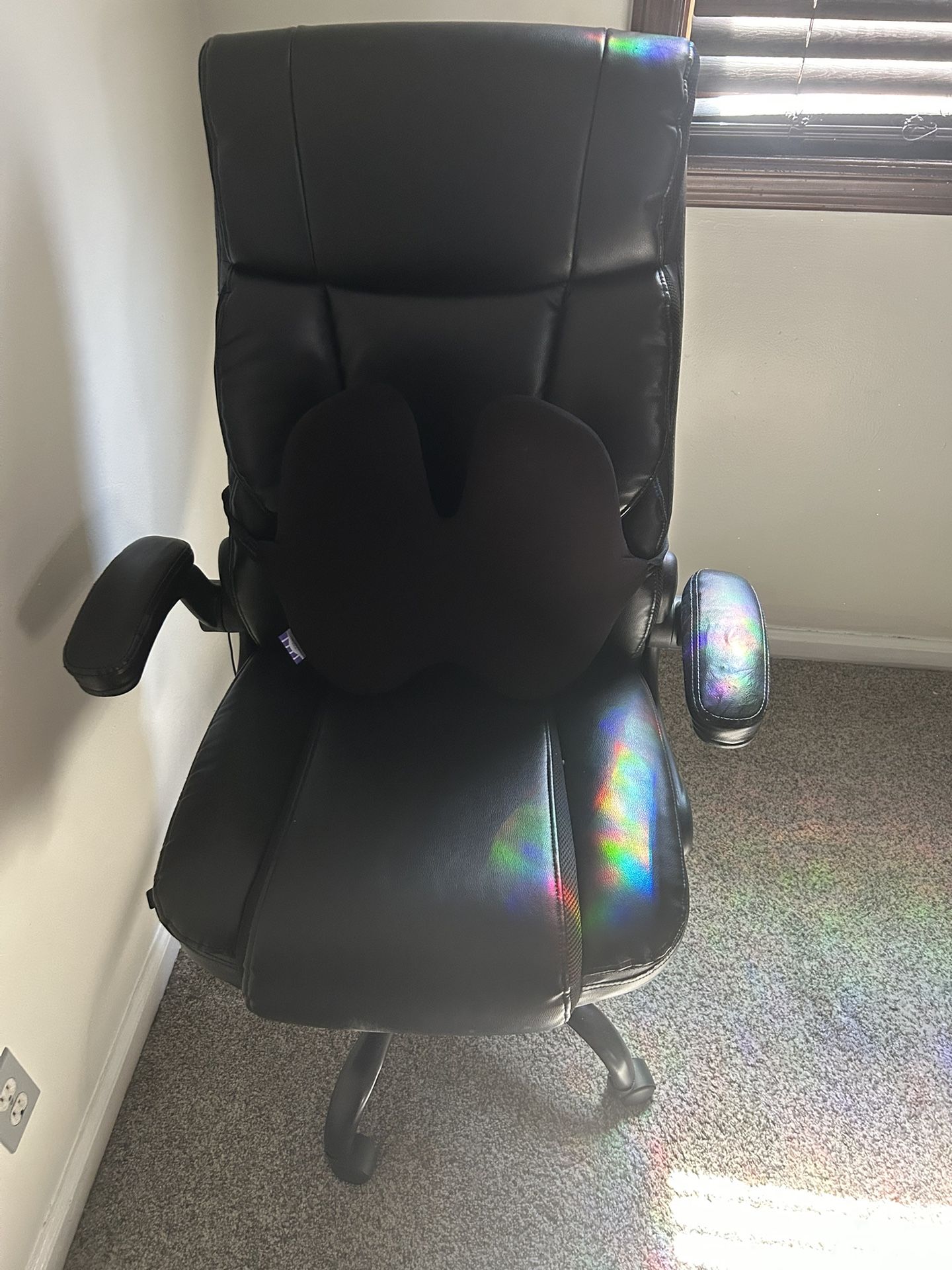 ergonomic office chair with a lumbar support cushion.