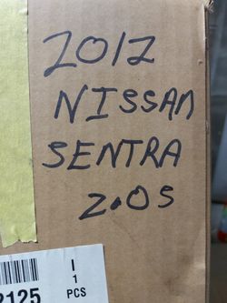 This is a left side headlight for a 2012 Nissan Sentra