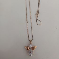 Little chain with angel charm. I think it's gold-plated, I'm not sure.